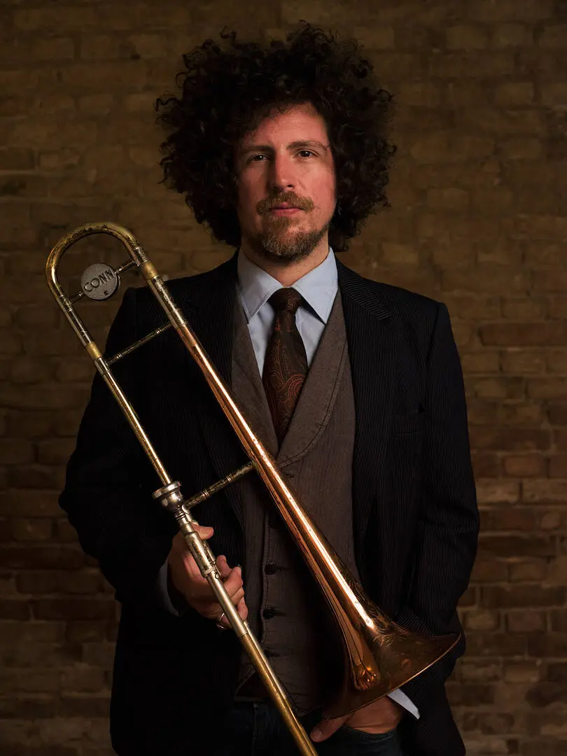 Carlos Santana playing trombone and piano with The Jungle Jazz Band, ideal for vintage jazz festivals and private celebrations.