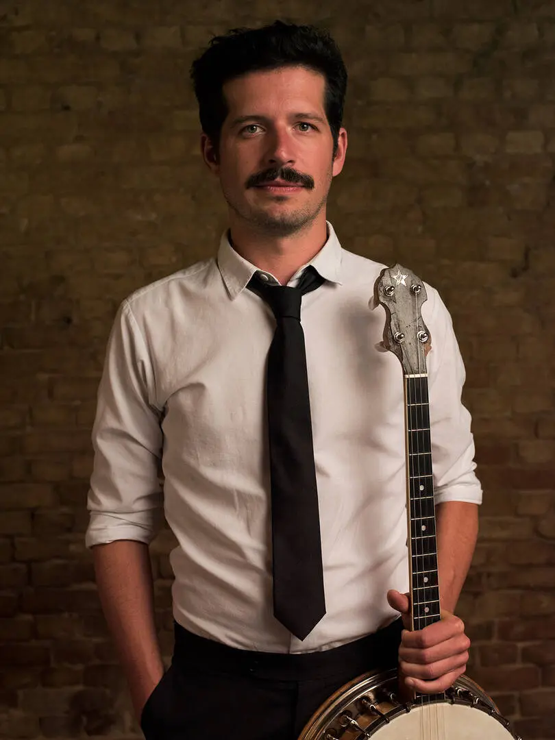 Thomas Dekas with a gypsy jazz guitar and tenor banjo, providing the rhythm for Gatsby and private parties